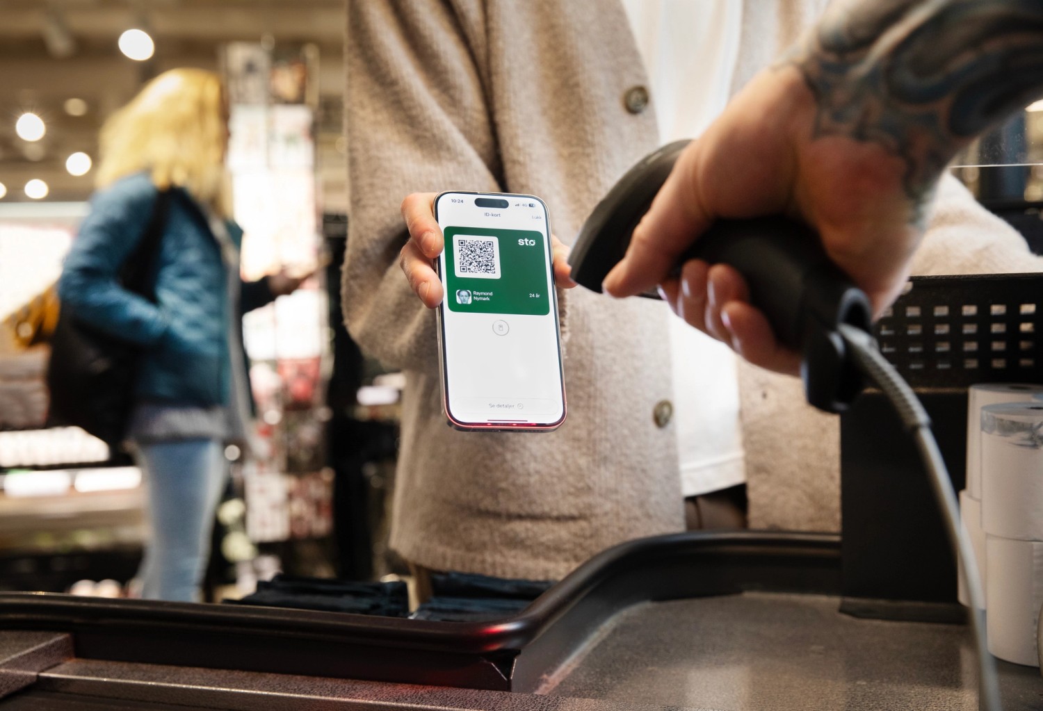 An ID card is scanned at checkout